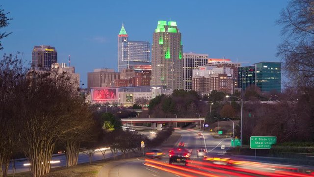 Raleigh NC Cityscape Night Timelapse with Moving Traffic Entering Downtown as the Sun Sets into the Night Showcasing the Lit Building Landscape of the North Carolina Capital City
