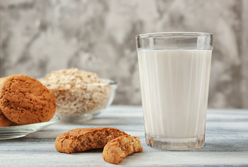 Oatmeal cookies with milk on table