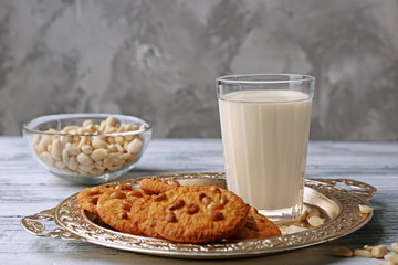 Peanut cookies with milk on tray on table