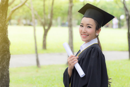Women Student Graduate holding certificate in her hand and feeling so happiness in Commencement day