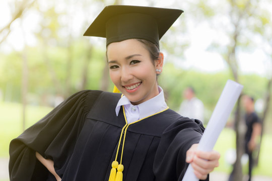 Graduate holding certificate in her hand and feeling so happiness in Commencement day