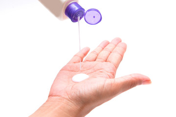 woman pouring body lotion on hand