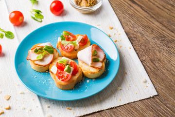Bruschetta with tomato, cheese and bacon