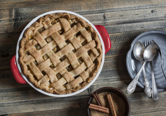 Apple pie on wooden table, top view