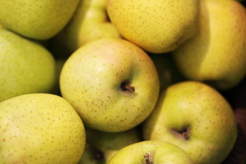 Yellow juicy apples background. Close up