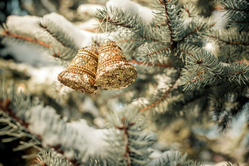 Christmas background with golden bells on the Christmas tree 