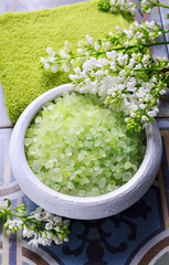 Green sea salt and lilac flowers