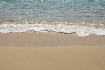 sea water surf to beach in sunny day