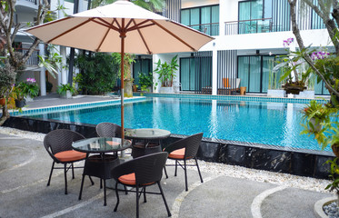 Relaxing rattan chairs beside swimming pool
