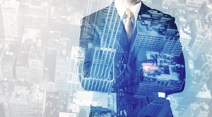 Business person standing with cityscape in the background