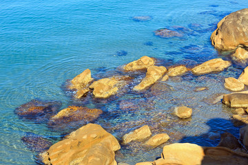 Stones in clear sea water.