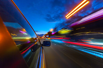 View from Side of Car moving in a night city.