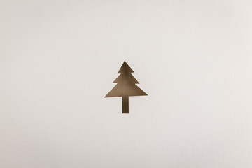 cutting brown Christmas tree