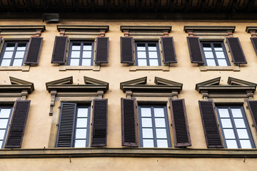 windows on facade of old house in Florence