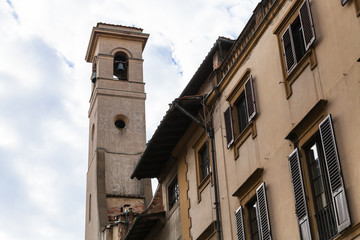 Fototapeta na wymiar bell tower over old houses in Florence