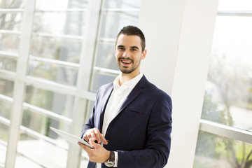 Businessman using his digital tablet at the office