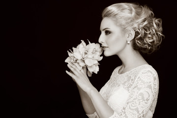 Duotone profile portrait of young beautiful bride with stylish prom hairdo