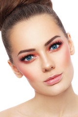 Obraz premium Close-up portrait of young beautiful blue-eyed woman with stylish sunny make-up over white background