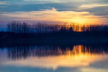 Sunset on the lake. Reflections in water.