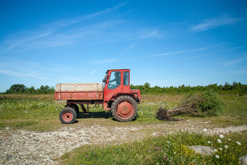 Red tractor at work.