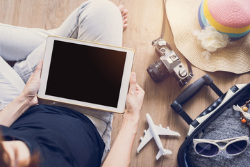 Women using tablet and prepare to travel on holiday