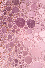 Oil drops floating in water abstract color background.