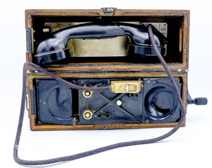 Old World War II military phone in wooden box.