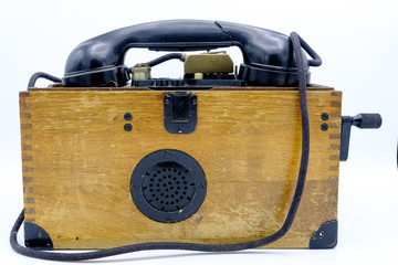 Old World War II military phone in wooden box.