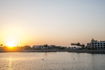 Obraz premium Amazing Sunset Sultanate Oman Souly Bay harbour and Hotels Oceanside