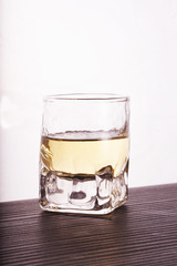 Glass of whisky over white