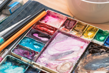 oil paints and paint brushes on a palette