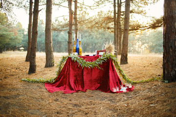 Table with candles and tea in the forest