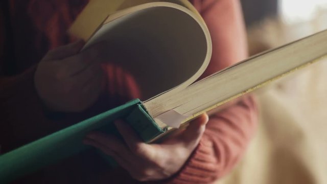 Man leafing through a large book