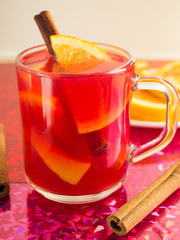 Mulled wine, cinnamon and orange to bright shiny background