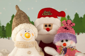 Santa Claus and snowman in winter forest.