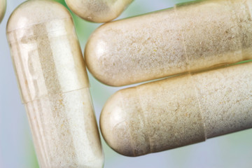 Glucosamine capsules, food supplement pills, top view, macro image.