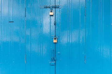Fototapeta premium Blue wooden door with the three padlock