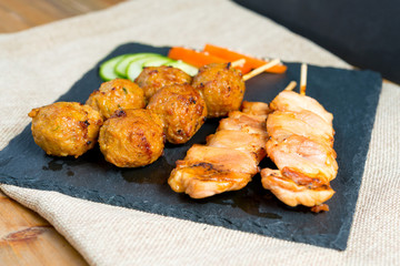 tasty kabobs with vegetables on a slate plate