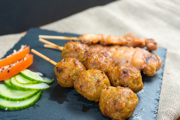 tasty kabobs with vegetables on a slate plate