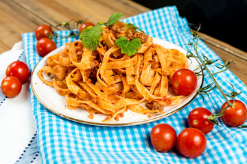 Spaghetti with aubergine and tomato on a the table
