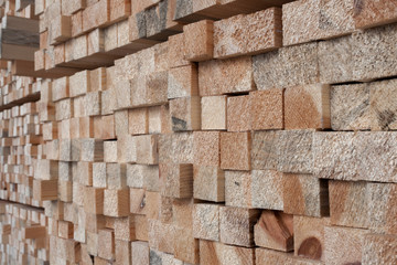 Wall of stacked on top of each other wooden pine sticks. Perspec