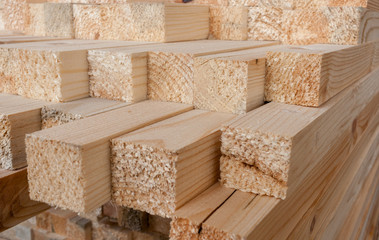 Close-up of unevenly  protruding sawn rectangular wooden pine bl