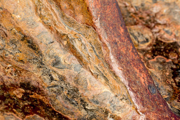 Close up of a rusting ships anchor:  The title 
