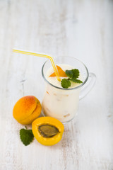 Smoothie or yogurt with blueberries on a wooden table. Delicious