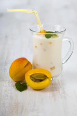 Smoothie or yogurt with blueberries on a wooden table. Delicious