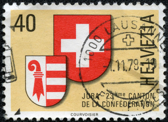 stamp printed in SWITZERLAND shows coat of arms of Jura canton
