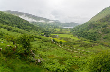 Fototapeta premium Looking down the scenic Valley towards Llyn Gwynant one of the many beautiful lakes in and around Snowdonia National Park North Wales.