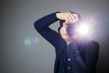 Photographer takes a picture in the studio using a flash - Powered by Adobe