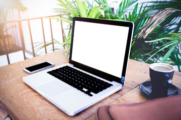 laptop with blank screen on table. In the coffee shop.