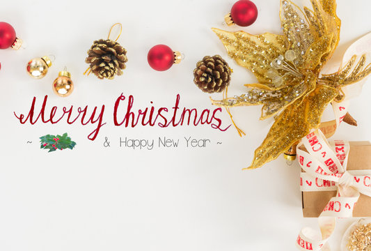 Christmas flat lay styled scene with golden decorations, copy space and merry christmas greetings